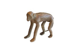 Vintage handmade African monkey figurine with a textured spine and rustic brown patina.