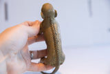 Rear view of the monkey figurine with a hand-carved herringbone pattern spine.