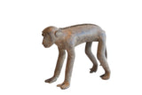 Vintage African monkey figurine standing with a textured spine and rustic brown patina.