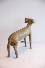 Hand-worked spine detail and aged patina on the rear of a vintage African ram sculpture.