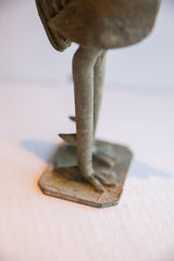 African rooster sculpture's aged bronze legs, clawed feet, and rough, irregular base.
