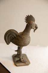 Three-quarter view of the African rooster sculpture with its detailed comb and worm.