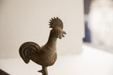 Textured head and ridged neck of the vintage African rooster sculpture.
