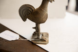 Vintage African rooster sculpture's textured legs and rustic base with white string.