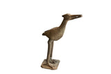 Vintage handmade African bird sculpture with rustic texture holding a fish in its beak.