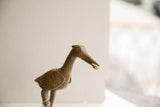 Side profile of the African bird sculpture showing its textured head and carved eye.