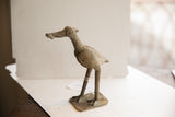 Three-quarter view of the vintage African bird sculpture highlighting its etched texture and form.
