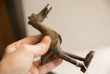 Vintage African bird sculpture held in hand to show its scale and handmade texture.