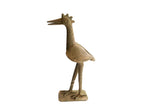 Vintage handmade African bird sculpture in profile with a stylized crown and rustic texture.