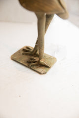 Aged patina on the handcrafted feet and square base of the vintage bird sculpture.