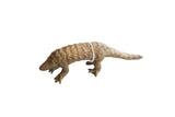 Vintage handmade African pangolin sculpture with detailed carved scales and a weathered patina.