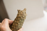 Handmade, overlapping scales with an aged patina on the vintage pangolin sculpture.