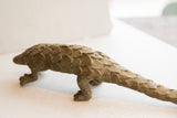 Hand-formed overlapping scales with a weathered patina on the vintage pangolin sculpture.