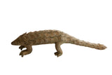 Vintage African pangolin sculpture with textured, overlapping scales and an aged patina.