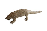 Vintage African pangolin sculpture with a weathered brown finish and textured, overlapping scales.