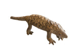 Vintage African pangolin sculpture with detailed hand-carved scales and an earthy, weathered finish.