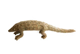 Vintage African pangolin sculpture with textured, overlapping scales and a rustic, earthy patina.