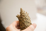 Detailed view of the vintage pangolin sculpture's handmade, overlapping scales.