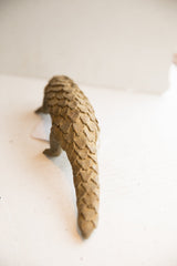 Rear view of the vintage pangolin sculpture highlighting its textured, overlapping scales.