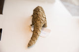 Rear view of the vintage pangolin sculpture, highlighting its hand-carved, scaly tail.