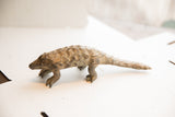 Profile of a vintage African pangolin showing handmade texture and aged patina.