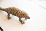 Close-up of the vintage pangolin's head, showing its snout and textured scales.
