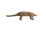 Vintage African pangolin sculpture with rustic handmade texture and overlapping scales.