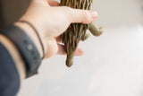 Detail of the handmade texture on the vintage porcupine sculpture's segmented tail.
