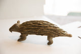 Vintage African porcupine sculpture in profile, showing its hand-sculpted quills and aged patina.