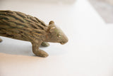 Close-up of the vintage porcupine sculpture's head, revealing its weathered patina and texture.