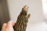The handmade porcupine sculpture's textured head and ears seen from below.