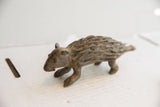 Profile view of a collectible African porcupine sculpture with hand-carved texture.