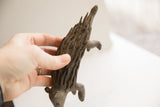 Vintage handmade porcupine sculpture held in a hand to show its size and texture.
