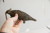Vintage African porcupine sculpture held in hand to show its scale and textured surface.