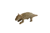 Vintage African porcupine sculpture with textured handmade details and an earthy finish.