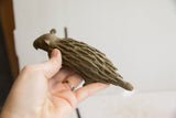 Vintage African porcupine sculpture held in a hand to show its scale and texture.