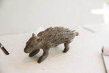 Collectible African porcupine sculpture in profile, showing aged, textured quills.