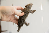The handmade charm and scale of a vintage porcupine sculpture shown in hand.