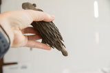 Vintage African porcupine sculpture held in hand, showing its scale and textured surface.