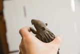 Profile view of the vintage African porcupine sculpture's hand-carved head and face.