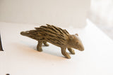 Vintage African porcupine sculpture showing its hand-formed quills and earthy texture.