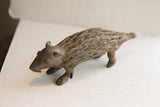 Side profile of the vintage African porcupine sculpture showing its textured, carved body.