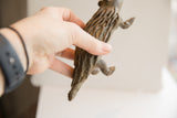 Side profile of the vintage porcupine sculpture highlighting its hand-carved quill texture.