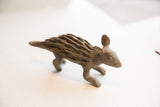 Earthy brown, spiky textured back and head of a vintage African porcupine sculpture.