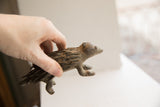 Hand holding the vintage porcupine sculpture, showing its scale and side profile.