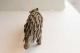 The layered texture of handmade quills on the back of a vintage porcupine sculpture.
