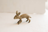 Side profile of a vintage African rabbit sculpture showing its rustic, handmade details.