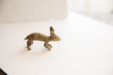 Side view of a vintage African rabbit figurine with rustic handmade charm.