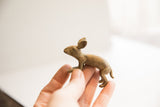 Vintage African rabbit figurine held to show its small scale and rustic texture.
