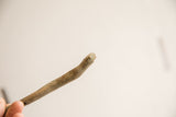 Close-up of the vintage snake figurine's head showing its simple handmade form.